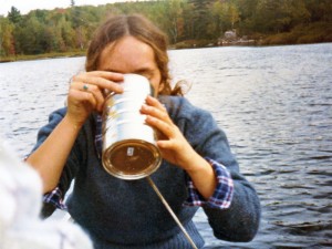 Young woman drinking from a bailing bucket