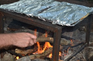 Pizza cooking over a fire.