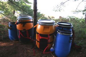 Five food barrels by the shore.