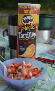 Fresh salsa and Pringles on a table