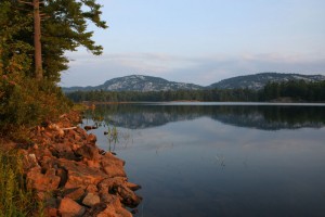 View of the red rocks and white mountains on Killarney Lake.