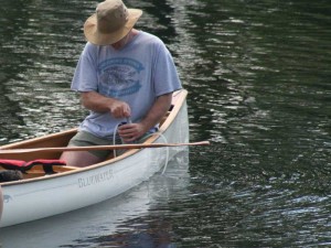 Pumping water from a canoe.