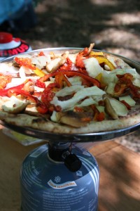 PIzza cooking on a small camp stove.