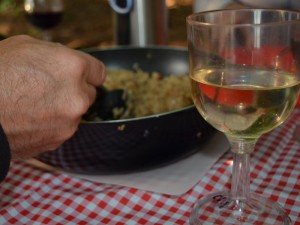 Glass of white wine with dinner on a table.