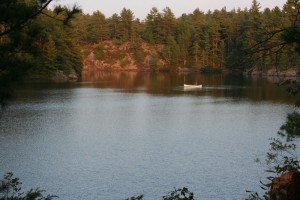 White canoe on the lake in the evening.