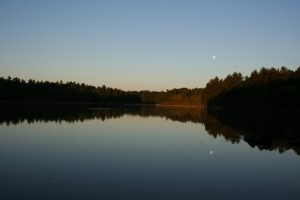 Sunrise on the lake with full moon.