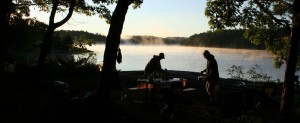 Two people with mist on lake