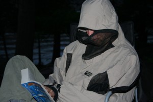 Man reading with a bug jacket on.