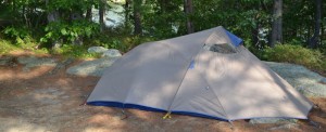 Small tent on flat dirt site.