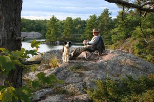 Man dog overlooking the lake.