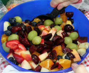 Fruit salad in a blue bowl.