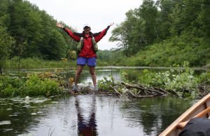 Woman standing on beaver dam