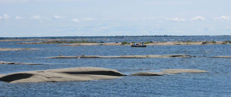 Canoe in the rock islands of a bay.