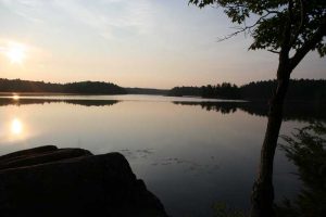 sun coming up on lake