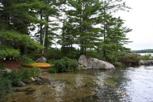 Sand landing with yellow canoe on shore