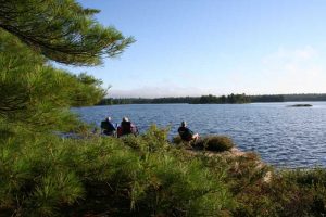 People sitting on shore in the morning sun