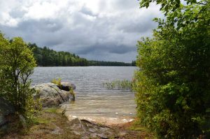 dark clouds, rock point and sand beach