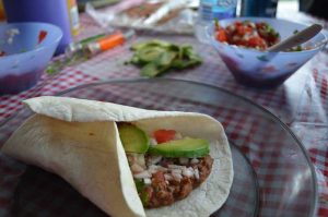 burrito with beans, salsa and rice in a wrap.