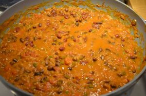 chili in a large pot cooking.