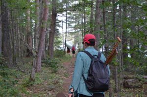 woman walking a portage with small pack.