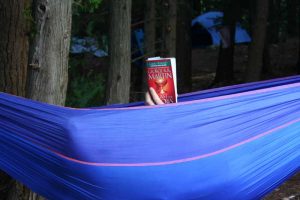 man in hammock reading