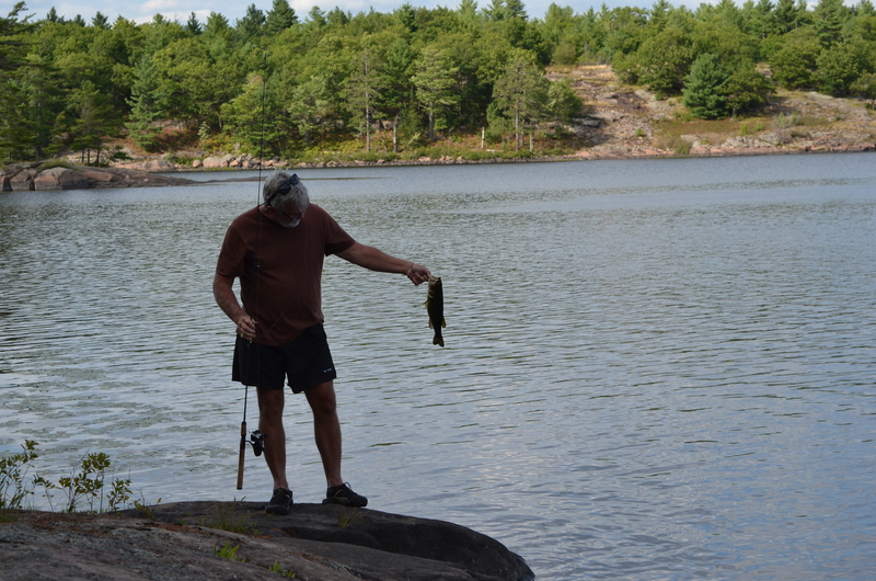 Man holding a fish on shore