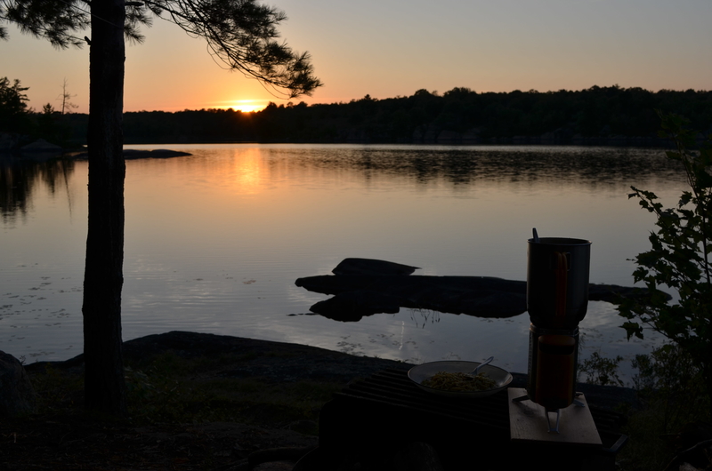 Sunset over lake with stove