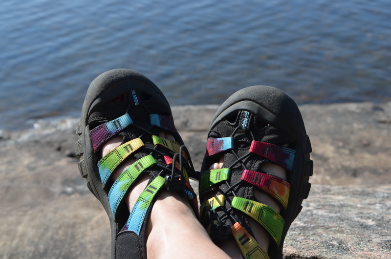 multicoloured sandals by the lake