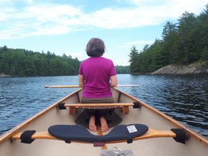 women in pink shirt in canoe