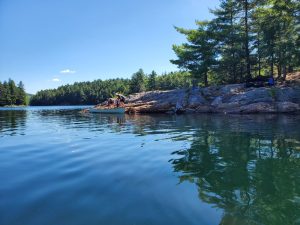 Rock shore, canoe being loaded